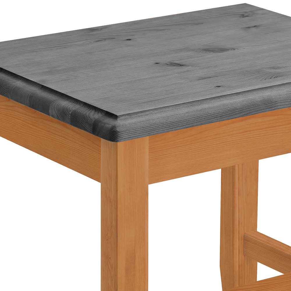 Graue Holzplatte und laugenfarbiges Hockerbein im Detail – Eshelas