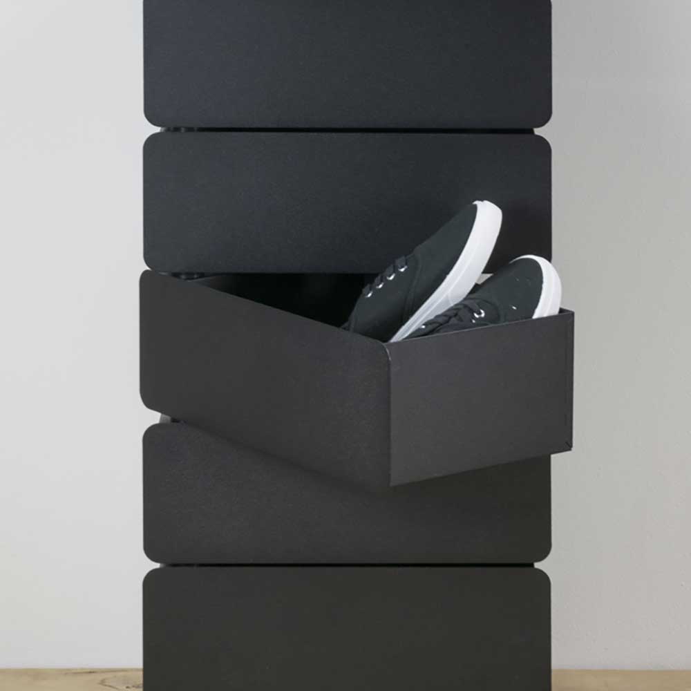 Schwarze Kommode mit einer geöffneten Schublade und Schuhen – Locoro
