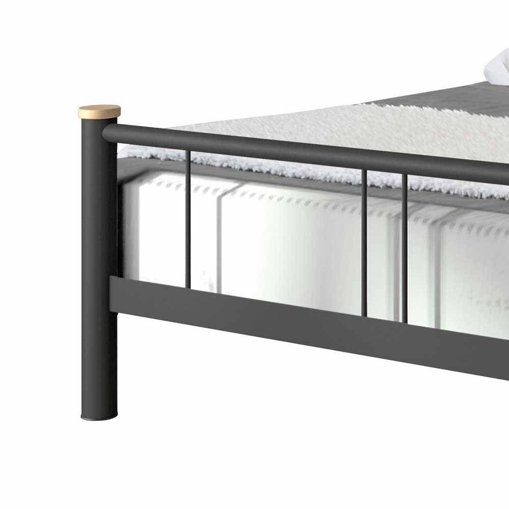 Modernes Futonbett aus schwarzem Metall mit Holzdetail am Fußende – Amsolia