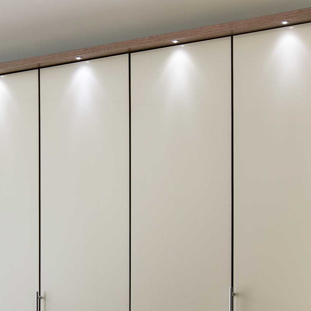 Integrierte LED-Beleuchtung auf der Oberseite des beige Falttürenschranks – Budelli