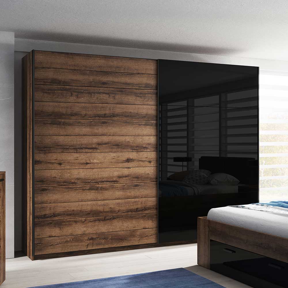 Zweitüriger Schwebetürenschrank in dunkler Holzoptik und schwarzem Hochglanz im Schlafzimmer – Ulpro