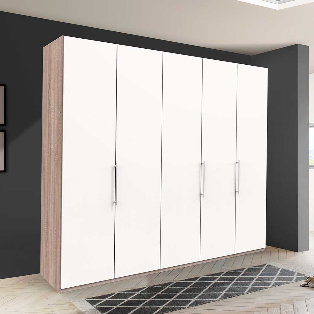 Kleiderschrank Vaclyn weiß mit heller Holzoptik, drei Falttüren und Metallgriffen – Vaclyn