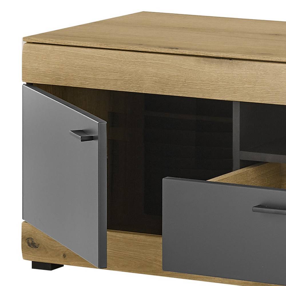 Seitliche Ansicht des TV-Sideboards mit geöffneter Tür und Schubfach für Zubehör – Addara