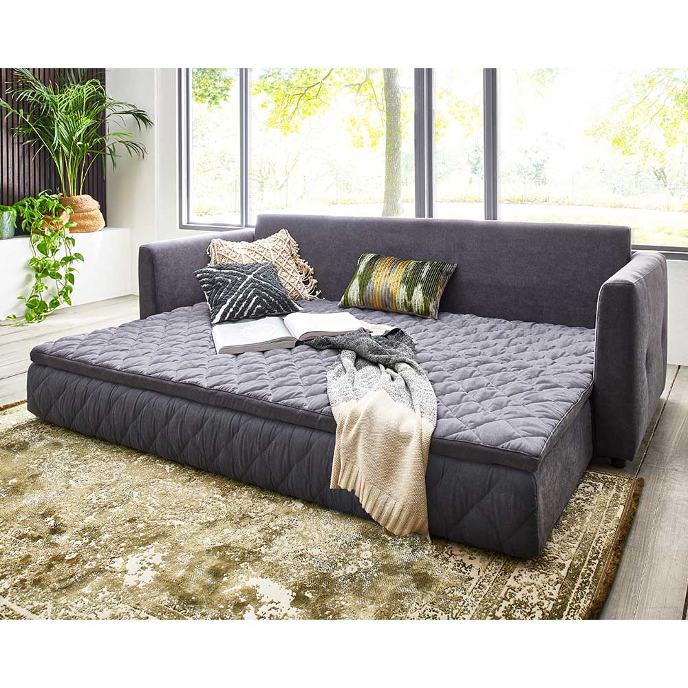 Ausgezogenes dunkelgraues Schlafsofa mit Taschenfederkernmatratze und gesteppter Oberfläche – Riconia