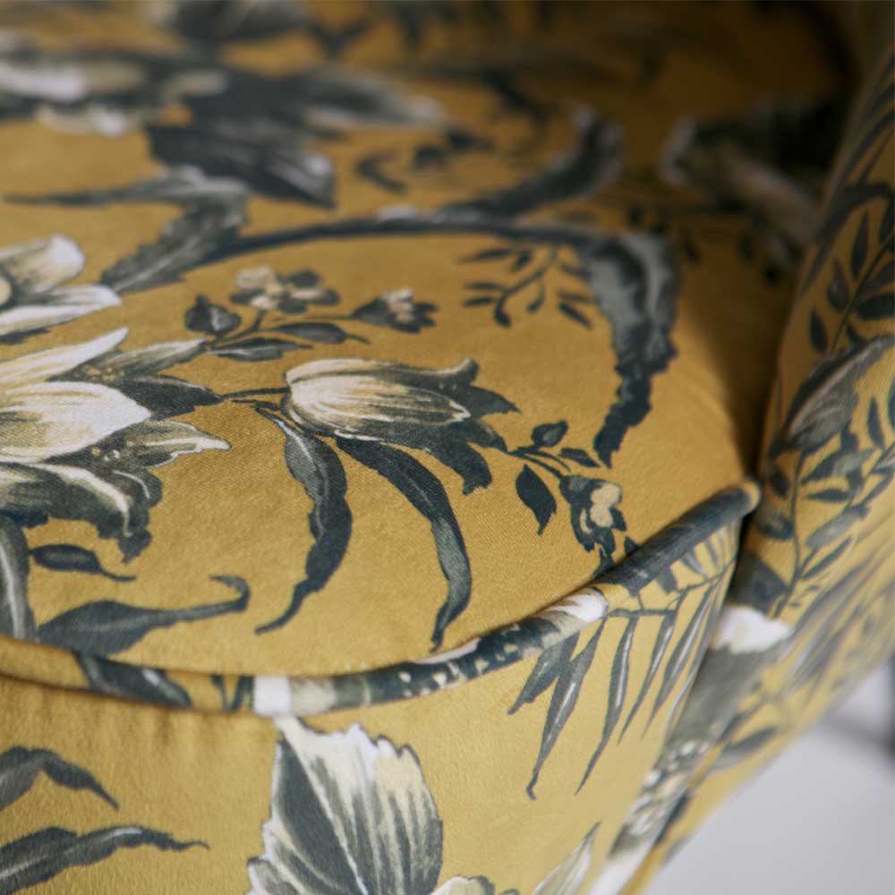 Detail der Sitzfläche des gelben Sessels mit feinem Blumenmuster und weicher Polsterung – Citylife