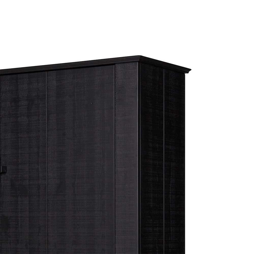Obere Ecke des schwarzen Holzschranks mit eleganter Abschlussleiste und Maserung – Jantala