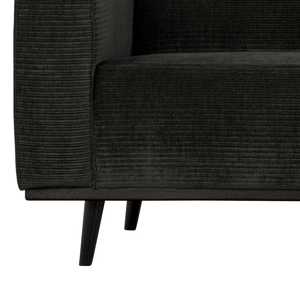 Schwarze Füße und die Kante des Federkern Sofas mit Cordbezug in Dunkelgrau – Rouge