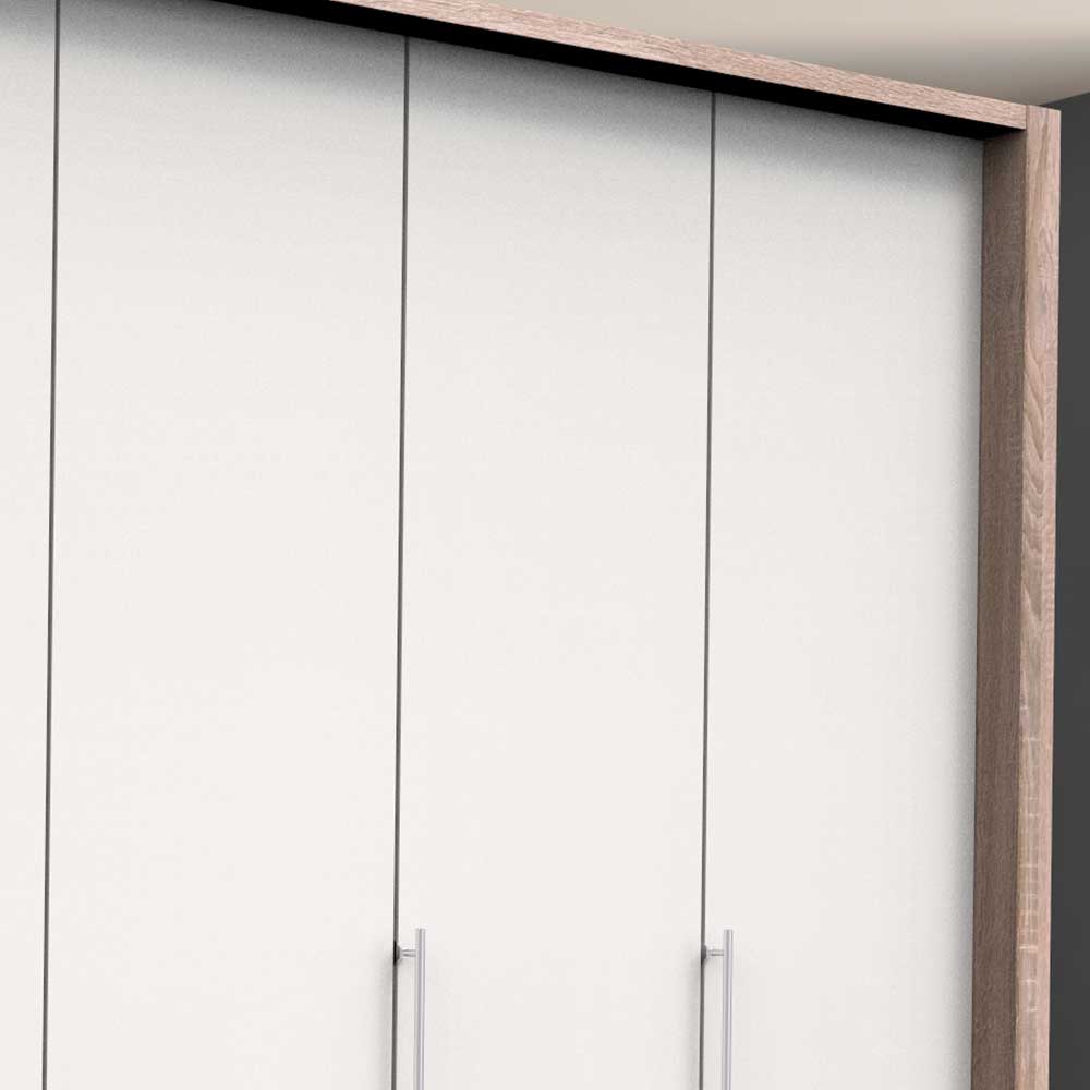 Oberer Bereich des Kleiderschranks mit weißen Türen, modernen Griffen und Rahmen in heller Holzoptik – Vaclyn
