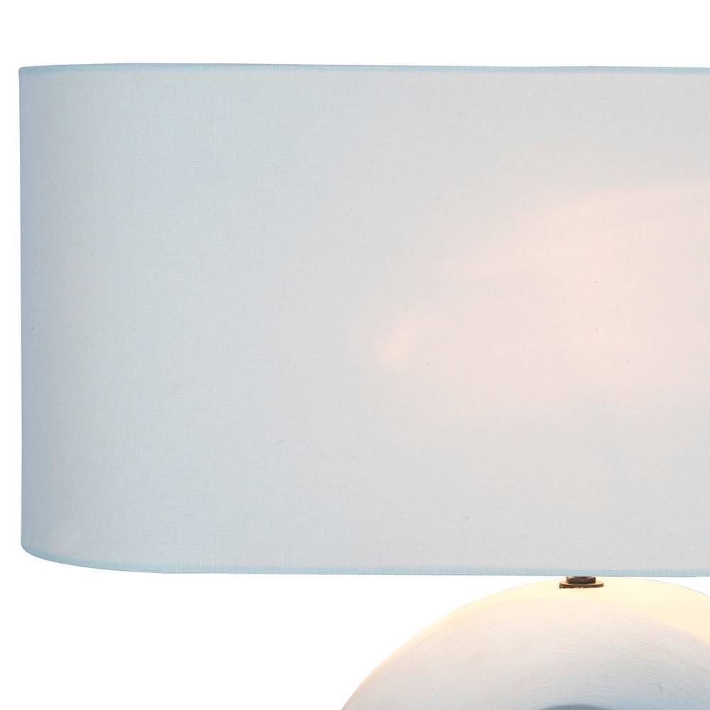 Heller, cremefarbener Textilschirm der Tischlampe von unten beleuchtet – Lidello