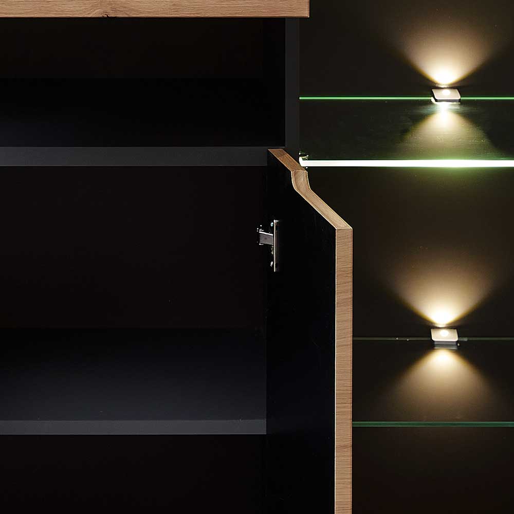 Innenansicht des Highboards mit geöffneter Holztür, dunklem Stauraum und leuchtenden Glasablagen – Kuetra