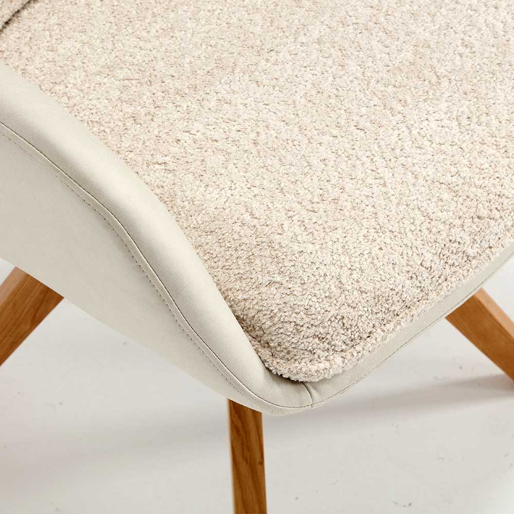Detail der cremefarbenen Bouclé-Sitzfläche und der robusten Eichenholzbeine des Esszimmerstuhls – Compadro