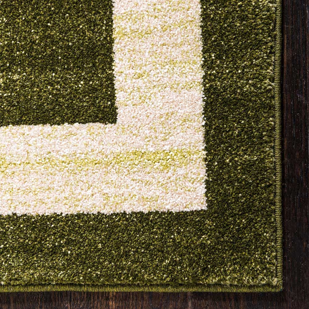 Teppich in Oliv Grün mit Rahmen in Creme - Loritana