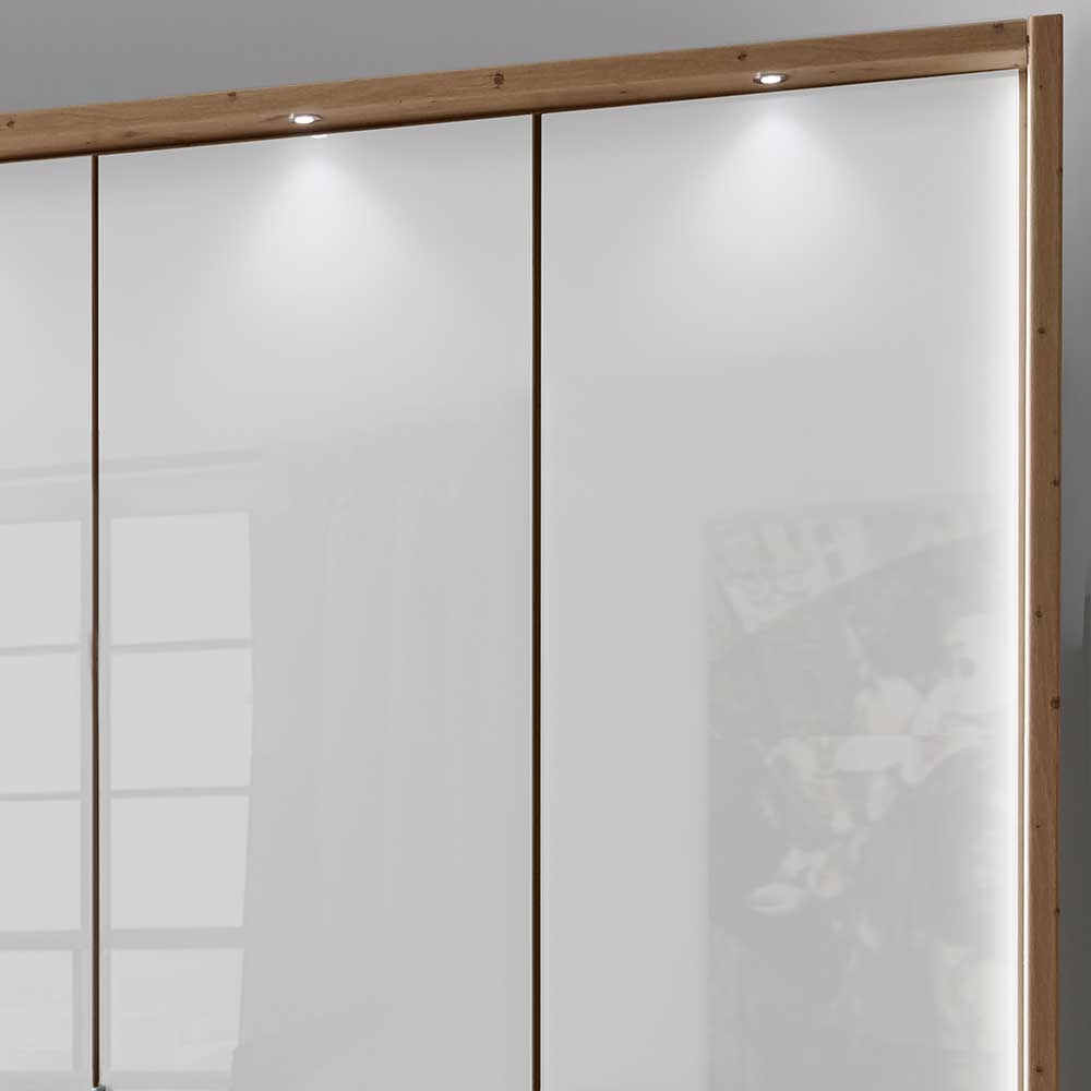 Kleiderschrank mit integrierter LED Beleuchtung und elegantem Holzrahmen oben – Malvido
