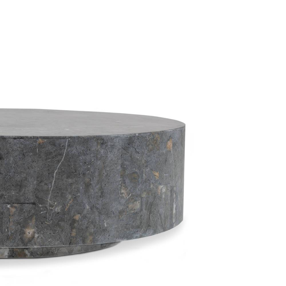 Seitliche Ansicht des runden Couchtisches aus grauem Stein mit zylindrischer Form und Textur – Dezi