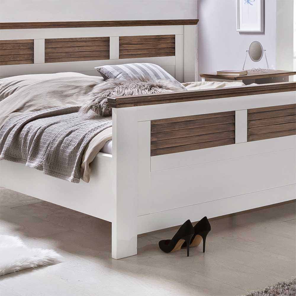 Weiß-braunes Landhausbett mit stabilem Holzrahmen und elegantem Fußteil – Dubanos