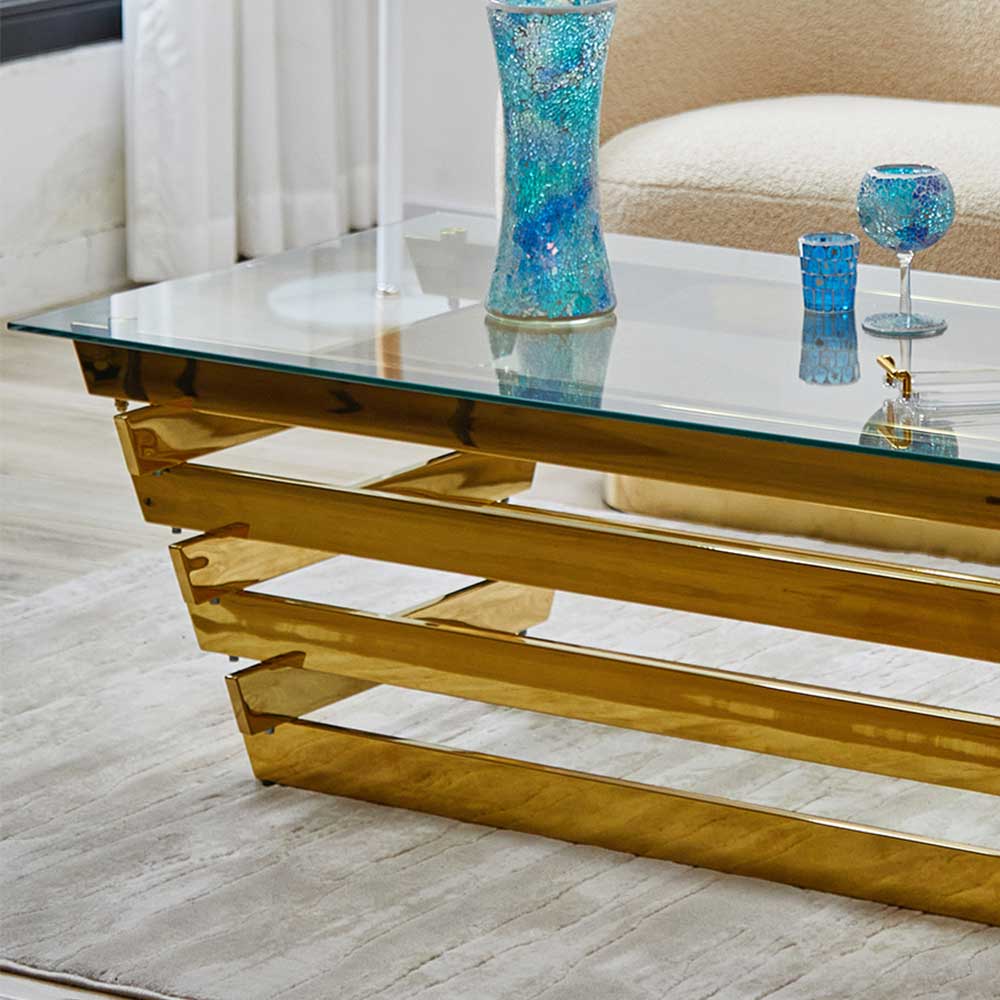 Goldener Couchtisch mit eleganter Glasplatte und gestuftem Metallgestell für das Wohnzimmer – Laduvia