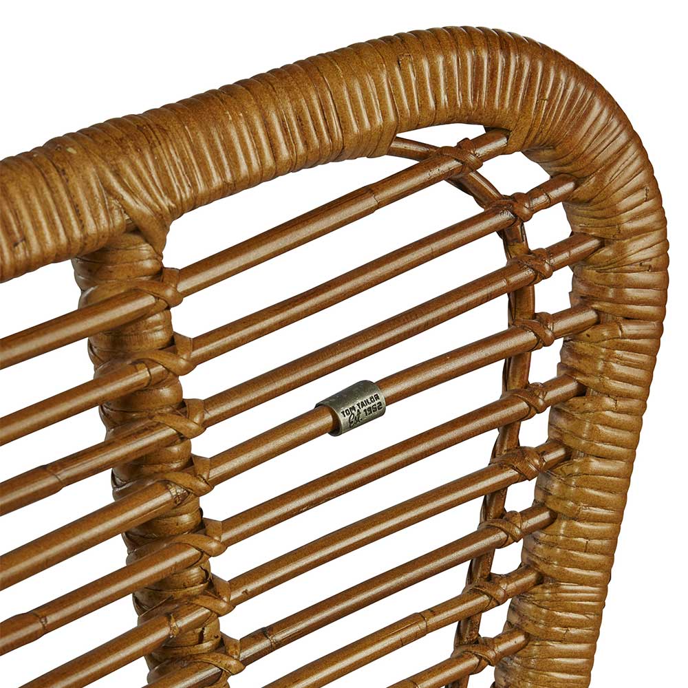 Kleines Metall-Logo von Tom Tailor im geflochtenen Rattan der Lehne – Krems