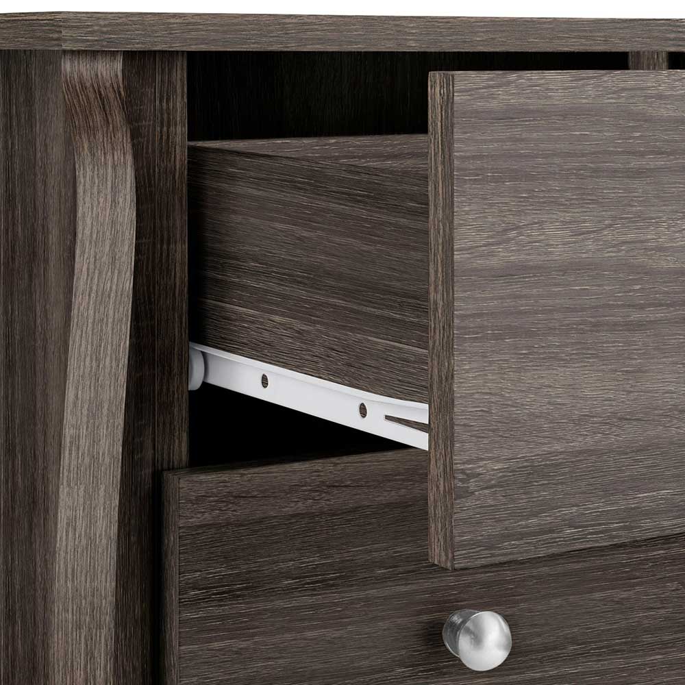 Geöffnete Schublade einer dunklen Holzkommode mit Metallauszug – Fionora